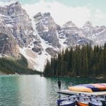 man standing on edge of boat on Banff National Park